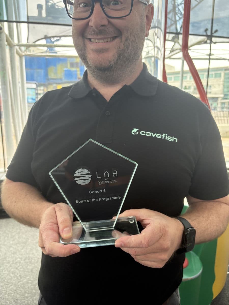 A Cavefish team member holding the LAB Spirit of the Programme award