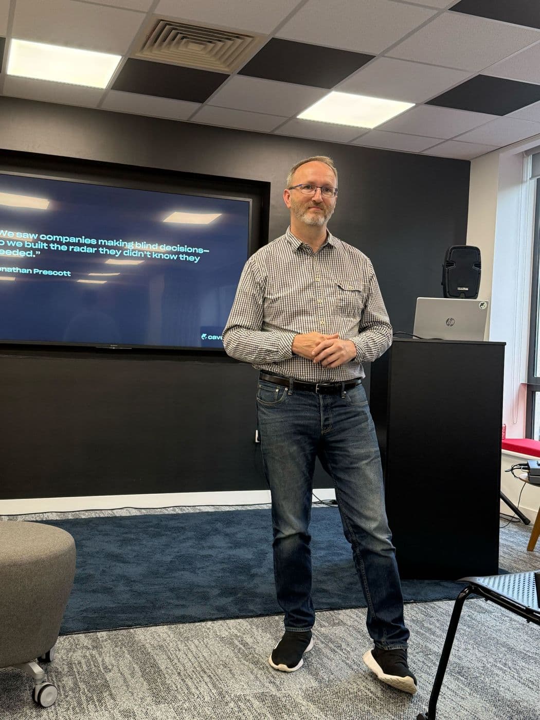 Jonathan Prescott presenting in front of a large screen
