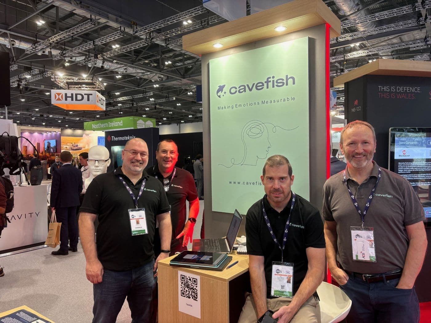 Four members of the Cavefish team at the Cavefish stand at DSEI